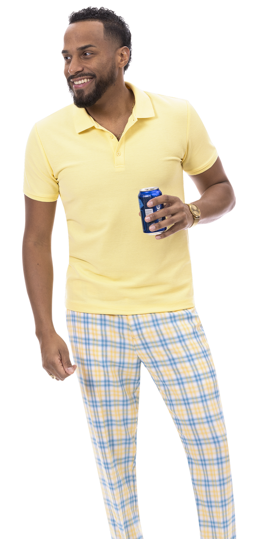 A cheerful person in a yellow polo shirt and EJ Samuel Blue Plaid Pants PL133 by EJ SAMUEL holds a can, smiling brightly while glancing to the side.