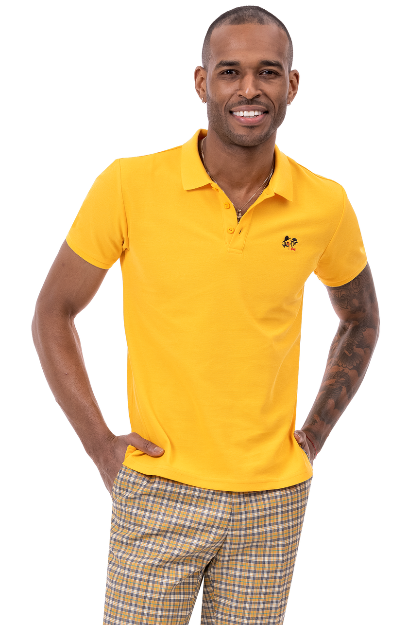 A person wearing a yellow polo shirt and the EJ Samuel Gold Plaid Pants PL81 from EJ SAMUEL stands with hands in pockets.