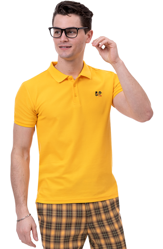 A man sporting glasses, a bright yellow polo shirt with a small logo, confidently stands in EJ Samuel Burned Orange Plaid Pants PL91.