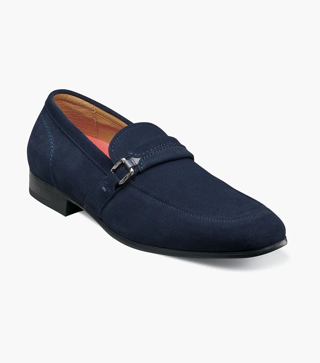 The Stacy Adams - QUILLAN Moc Toe Ornament Slip On features navy suede with a durable rubber outsole, embellished with a small metal buckle and complemented by a low black heel.