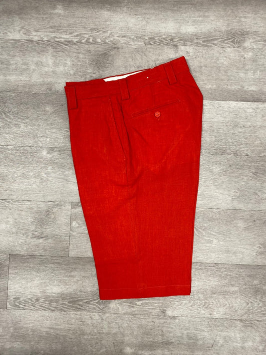 Inserch Premium Linen Flat Front Shorts in red, showcasing a visible back pocket, placed on a wooden floor—an ideal addition to your summer wardrobe.