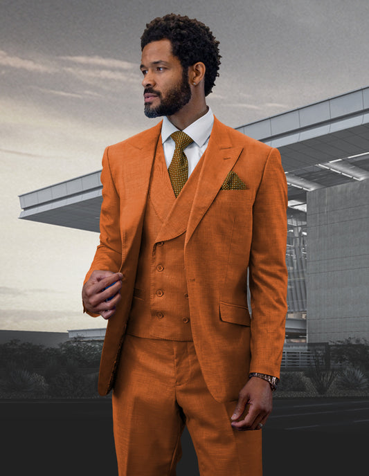 A man wearing the STATEMENT CLOTHING | RIMA-RUST suit with a peak lapel from Statement Clothing stands in front of a modern building, glancing to the side.