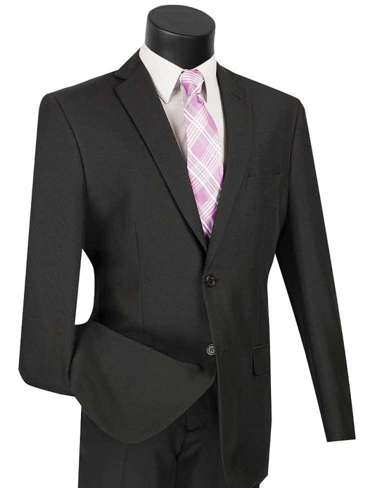 The Vinci Slim Fit 2 Piece 2 Button Business Suit (Black) from Vinci Suits is expertly showcased on the mannequin, complemented by a crisp white dress shirt and a stylish pink plaid tie. Its wrinkle-resistant elegance against a plain backdrop makes it ideal for any business event.