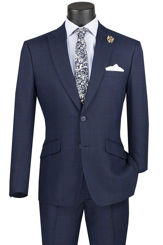 Mannequin adorned in the Vinci Suits' navy Vinci Slim Fit Suit with Peak Lapel and Stretch Armhole, paired with a crisp white shirt, a floral tie, and a pocket square. A decorative pin enhances the peak lapel.