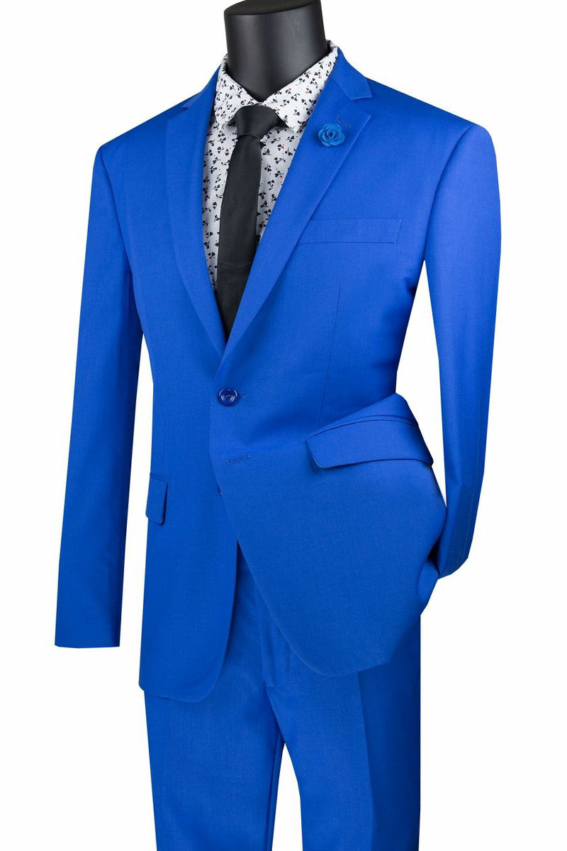 Displayed on the mannequin is the stylish Vinci Slim Fit 2 Piece 2 Button Suit in Royal, SKU SC900-12, by Vinci Suits. Crafted from a fine poly/rayon blend, this suit is paired with a white patterned shirt and black tie to offer an ensemble that combines elegance with wrinkle-resistant convenience, perfect for any formal occasion.