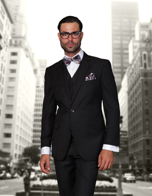 A man wearing the STATEMENT CLOTHING | STZV-100-BLACK suit by Statement Clothing, featuring tailored fit and flat front pants, stands amidst the cityscape.