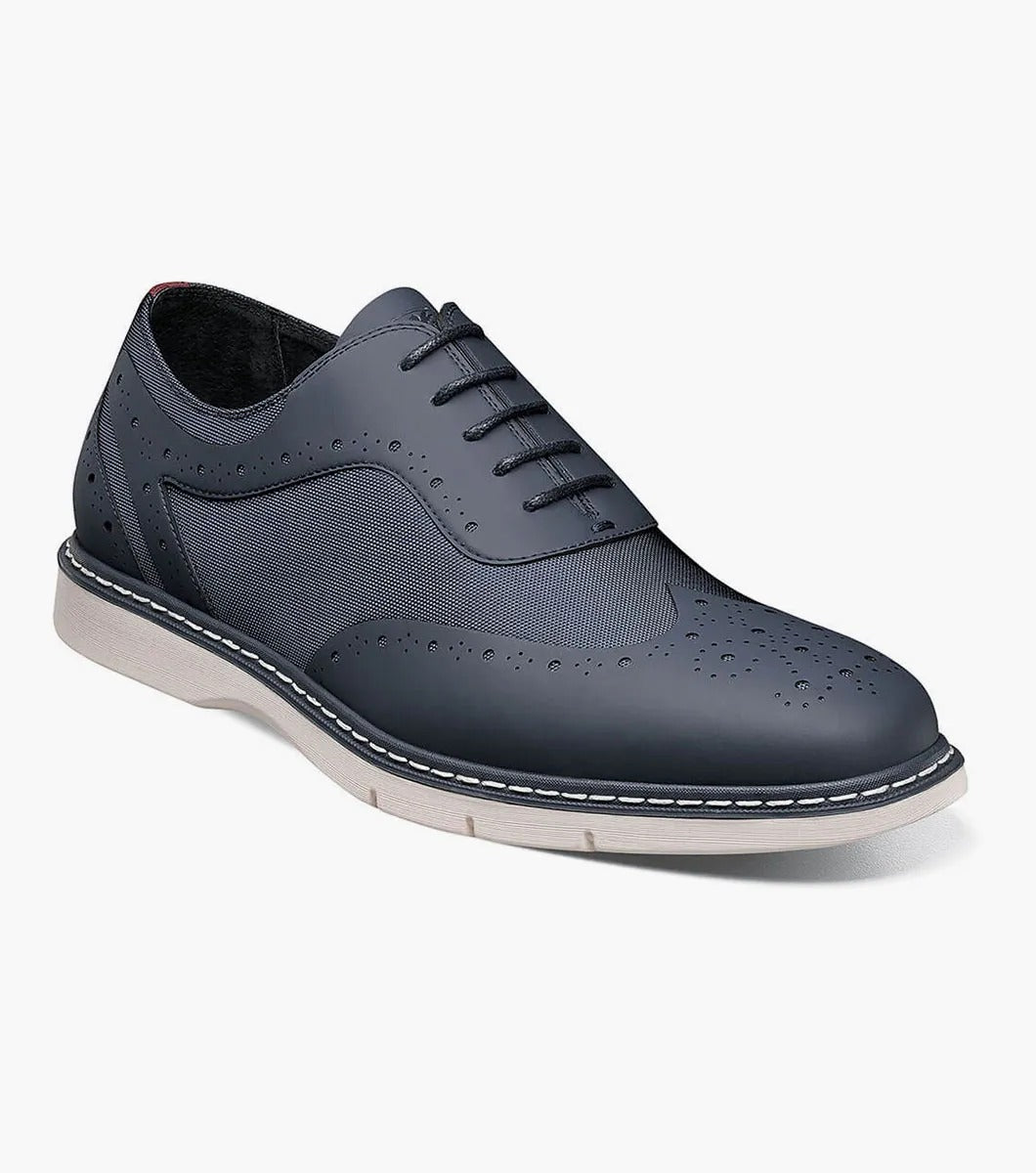 A single Stacy Adams - SUMMIT Wingtip Lace Up shoe in navy, featuring perforated leather with a white sole and wingtip design, viewed from the front.