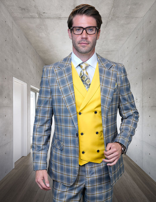 A man in a modern-fit plaid suit from Statement Clothing's SUNSET-GRAY collection, crafted from Italian wool, with a vibrant yellow vest and tie, stands in a concrete hallway, sporting glasses and a watch.