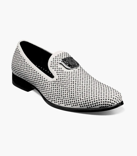 The Stacy Adams - SWAGGER Studded Slip On (Black with White, 25228-111) showcases a striking design with a white studded leather loafer contrasted by a black sole and adorned with a decorative metal emblem on top, offering both style and comfort thanks to its Memory Foam insole.