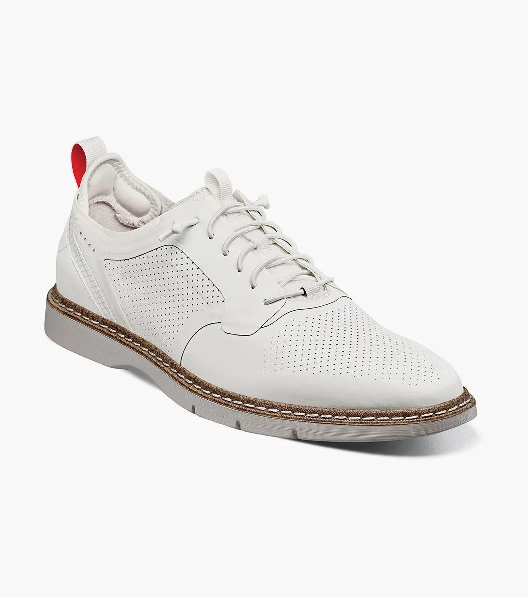 The Stacy Adams SYNCHRO Plain Toe Elastic Lace Up - White - 25518-100 is a versatile shoe showcasing white perforated leather with elastic laces, a brown sole, and a red pull tab at the heel. Crafted by STACY ADAMS for comfort, it offers anatomical arch support, making it ideal for any occasion.