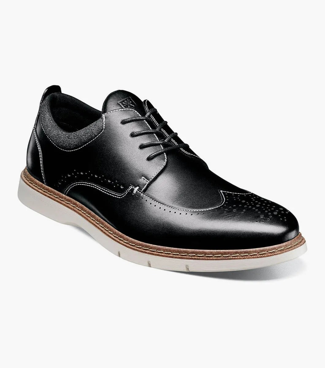 Stacy Adams' SYNERGY Wingtip Oxford in black (25418-001) showcases decorative perforations and a lace-up design, complemented by a contrasting light brown sole and featuring the RedZone footbed for enhanced comfort.