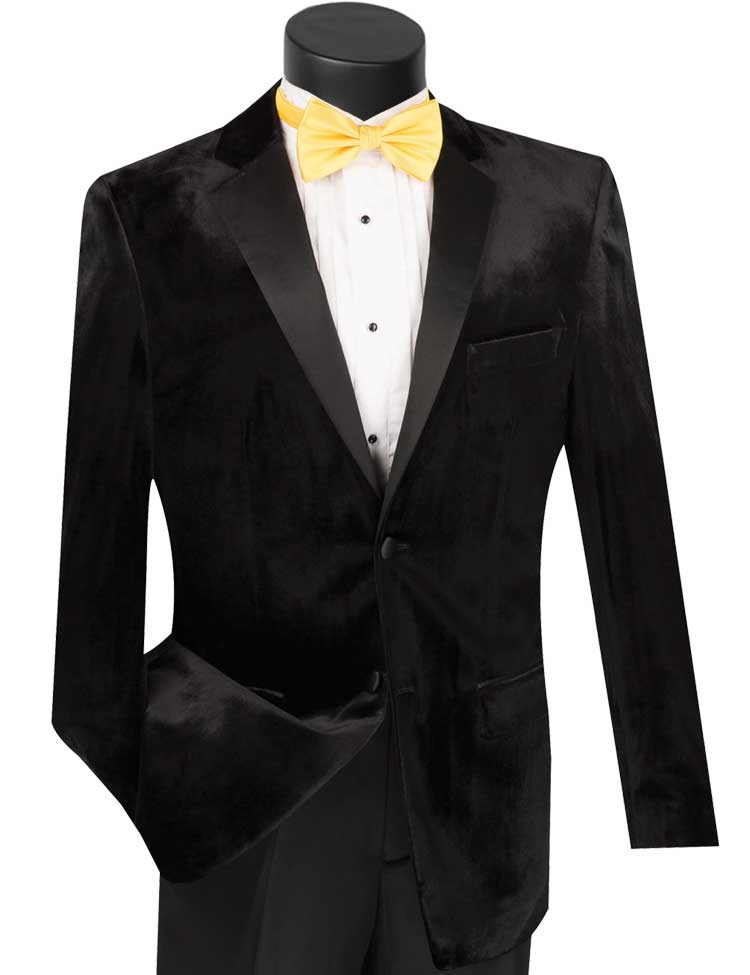 A mannequin showcases the Vinci Suits Vinci Slim Fit 2 Piece Velvet Tuxedo in black, featuring satin lapels, complemented by a crisp white shirt and a striking yellow bow tie. This ensemble is finished with single-breasted styling and sophisticated wool-blend pants, radiating timeless elegance.