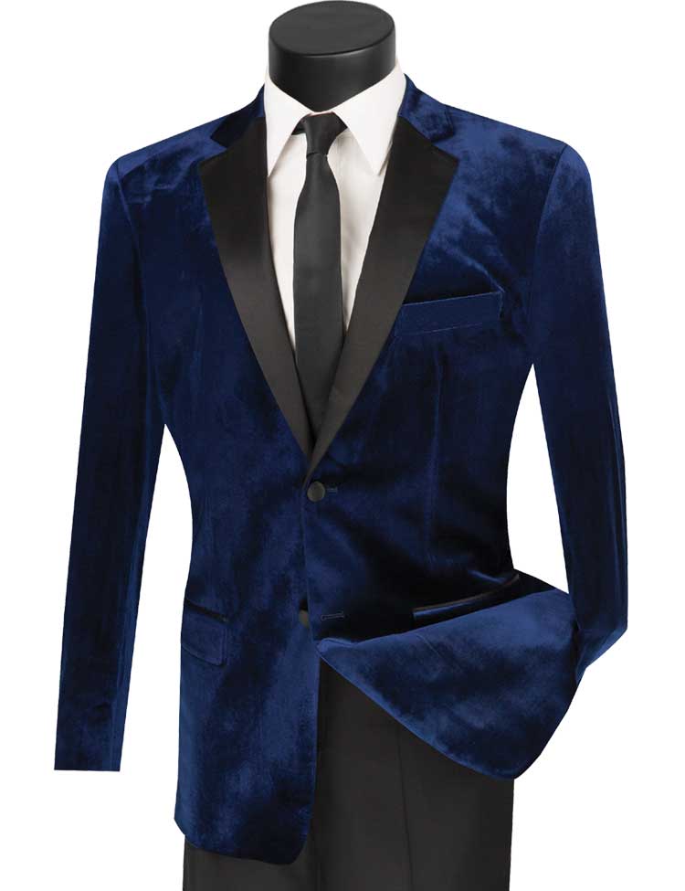 The Vinci Slim Fit 2 Piece Velvet Tuxedo in navy, featuring a black satin lapel, combines elegantly with a crisp white shirt and black tie on a mannequin. This look is perfectly completed with slim-fit wool-blend pants from the esteemed brand Vinci Suits.