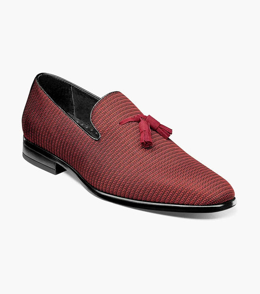 Introducing the Stacy Adams - Tazewell Plain Toe Tassel Slip On in Brick, characterized by its red textured design, black trim, and tassels on top. It features a fully cushioned footbed for ultimate comfort.