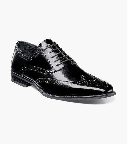 The STACY ADAMS TINSLEY Wingtip Oxford in black (model 25092-001) is crafted from polished buffalo leather, designed with decorative perforations and a low heel. It features Memory Foam cushioning for added comfort and is displayed against a white background.