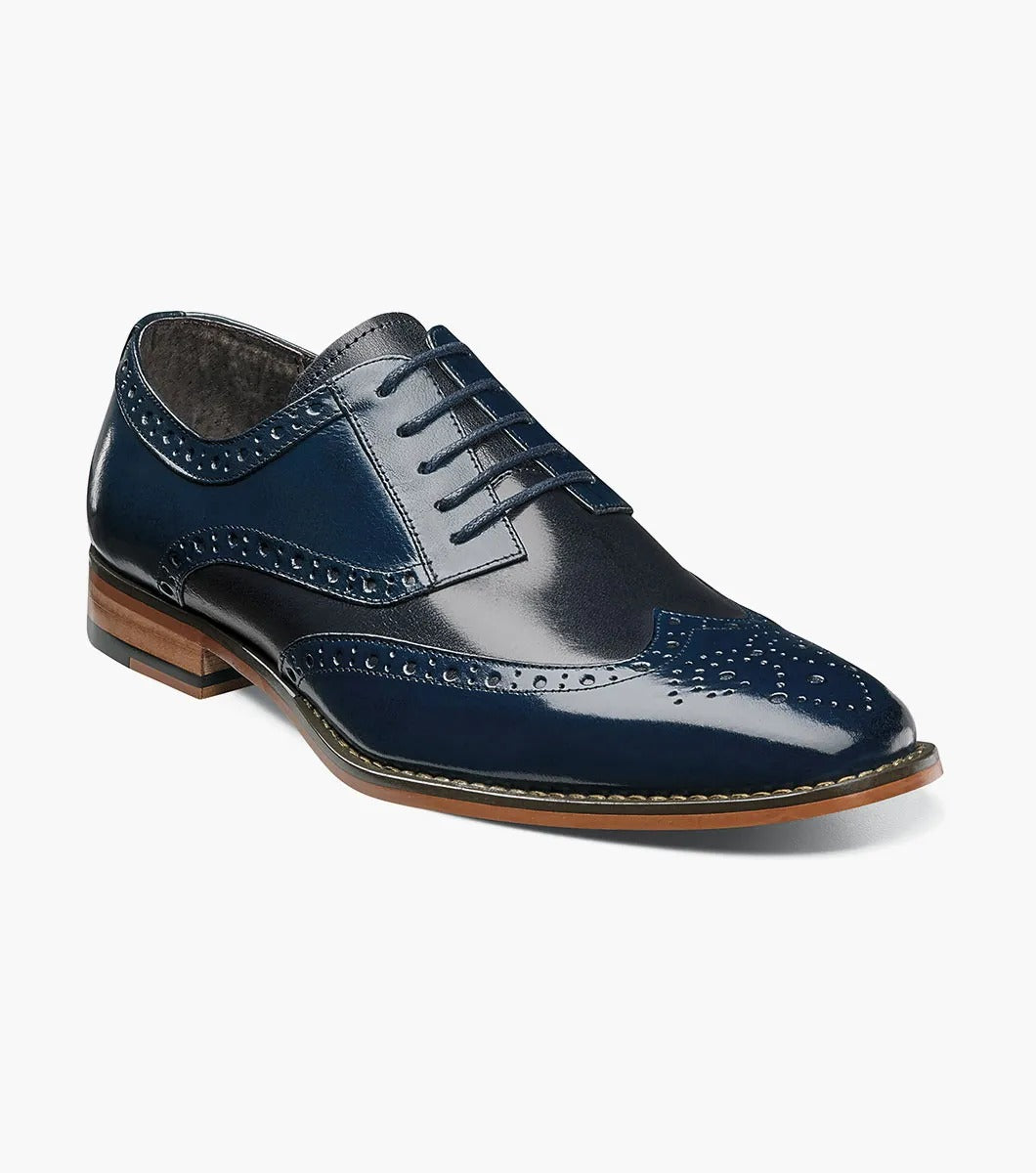 A Stacy Adams TINSLEY Wingtip Oxford in Cobalt Multi, featuring buffalo leather with decorative perforations, memory foam for added comfort, a wooden heel, and laces.