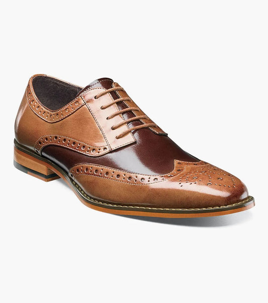 Stacy Adams presents the TINSLEY Wingtip Oxford in Tan Multi, featuring a stylish combination of dark and light brown buffalo leather sections, enhanced with decorative perforations and laces, all set against a white background.