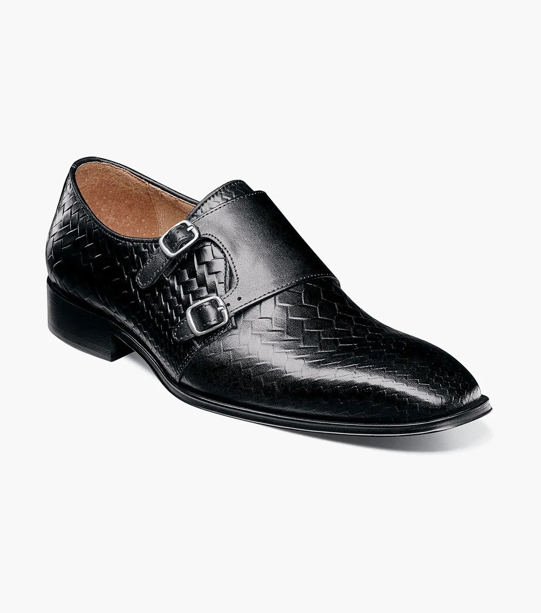 An angled view of the Stacy Adams - TORRANCE Plain Toe Double Monk Strap in Black offers a look at its black woven leather dress design, burnished finish, double monk strap, and low heel.