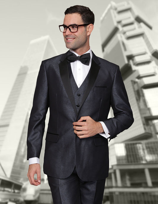 A man in a tailor-made STATEMENT CLOTHING | TURIN-2-BLUE tuxedo from Statement Clothing, crafted from fine Italian wool, stands smiling in front of the towering modern skyscrapers.