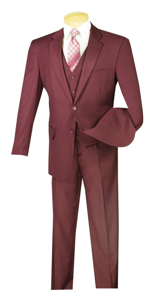 A mannequin showcases the Vinci Regular Fit 3 Piece Suit 2 Button in maroon by Vinci Suits, complemented by a crisp white dress shirt and a patterned pink tie.