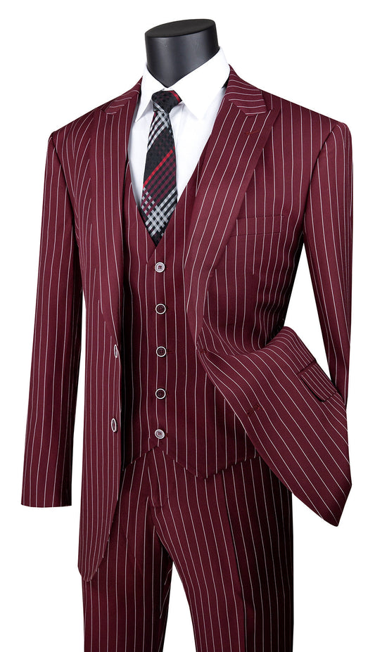 Introducing the Vinci Suits' burgundy masterpiece: the Vinci Regular Fit 3 Piece Suit 2 Button Gangster Stripe (Burgundy) V2RS-9. This distinguished ensemble, complete with a sharp peak lapel, exudes sophistication. When combined with a crisp white shirt and a black patterned tie, it creates an impeccably stylish look that remains wrinkle-resistant throughout your day.