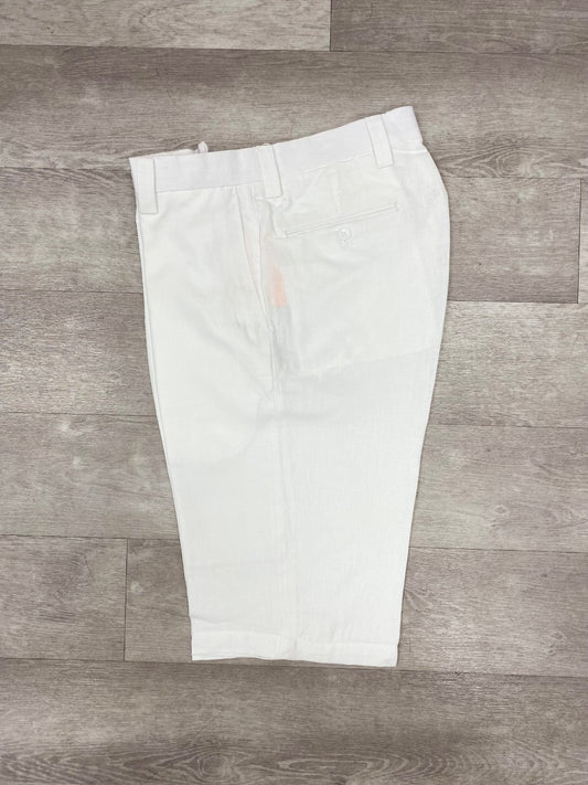 The Inserch Premium Linen Flat Front Shorts in White, from the brand Inserch, are elegantly displayed on a wooden floor, highlighting their back pocket and belt loops, making them an ideal addition to any summer wardrobe.