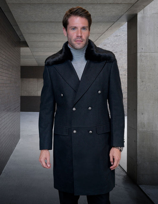 A man wearing the exquisite WJ-102-BLACK double-breasted coat by Statement Clothing, featuring a luxurious cashmere fur collar, stands in a concrete hallway.