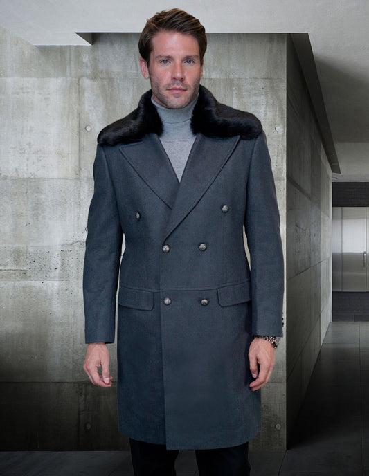 A man stands in a sleek interior wearing the Statement Clothing WJ-102-CHARCOAL jacket, crafted from a luxurious blend of wool and cashmere. This modern-fit coat features a double-breasted design and is accented with a sophisticated removable fur collar.