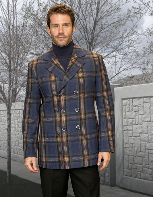 A man wearing a modern fit STATEMENT CLOTHING | WJ-104-BLUE plaid peacoat jacket stands in front of a stone wall and leafless trees.