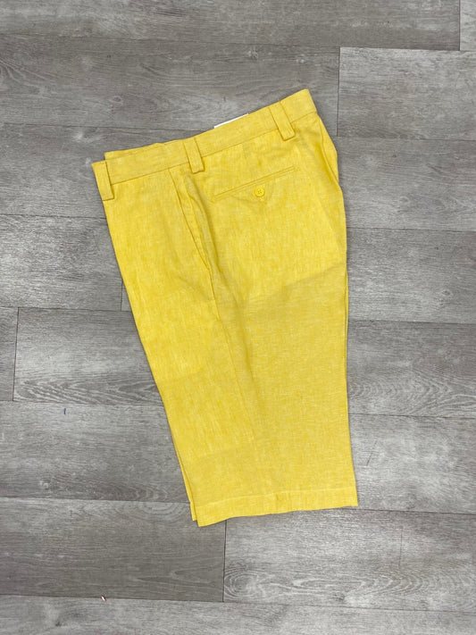 Inserch's Premium Linen Flat Front Shorts in yellow, featuring belt loops and a back pocket, elegantly displayed on a wooden floor, make an ideal addition to your summer wardrobe.