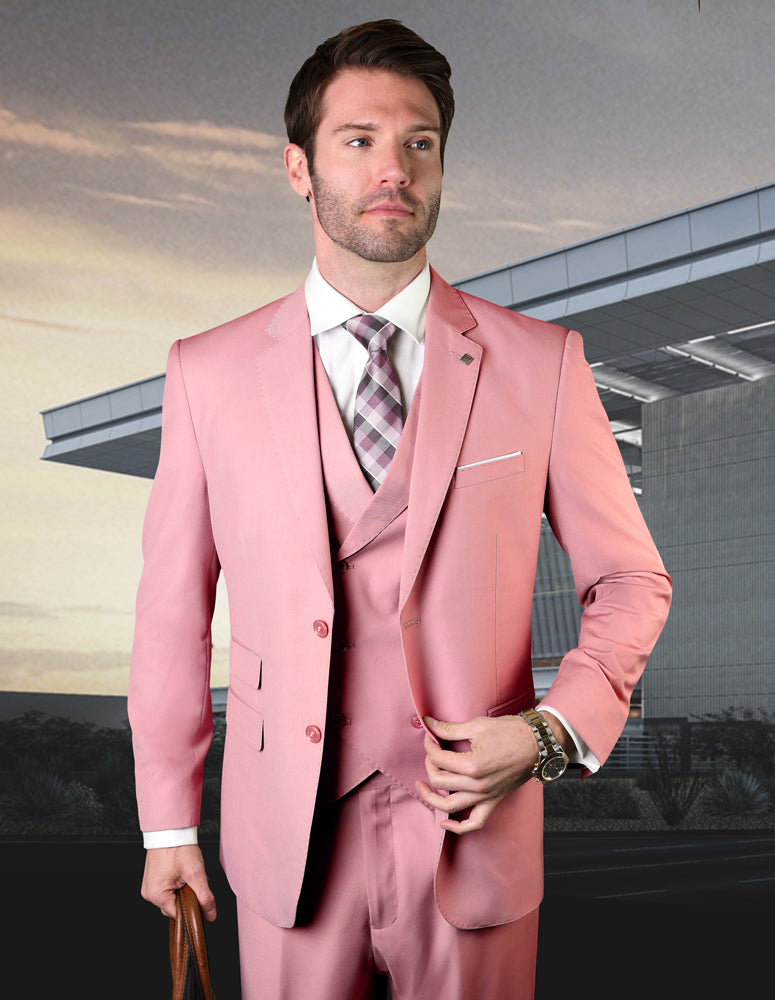 A man in a ZARGALA-BLUSH suit by Statement Clothing, complete with a modern fit and plaid tie, stands confidently in front of a modern building, holding a brown briefcase.