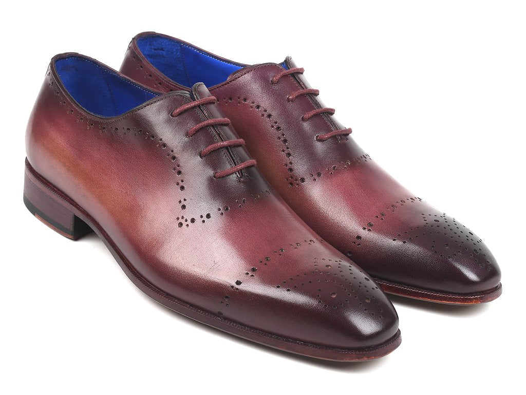 A pair of Paul Parkman Burgundy Hand-Painted Classic Brogues - ZLS35BUR, featuring a men's burgundy leather design with perforated details, hand-painted calfskin, and a blue interior lining, placed on a white background.