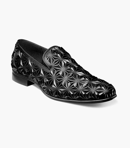 The Stacy Adams SEQUENCE Plain Toe Slip On in black, style number 25535-001, showcases a geometric star-shaped pattern across its 3D molded upper and is enhanced with Memory Foam for ultimate comfort.