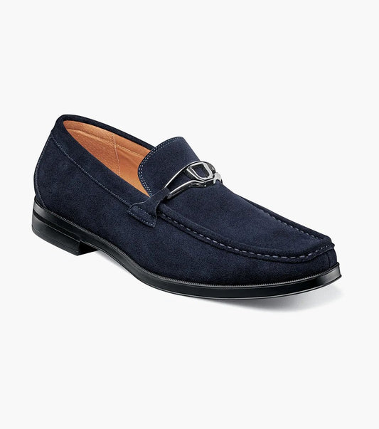 Stacy Adams introduces the PALLADIAN Moc Toe Slip On in Navy Suede (25549-415), showcasing a soft suede upper, metallic buckle detail, and black sole with a fully cushioned insole for exceptional comfort.