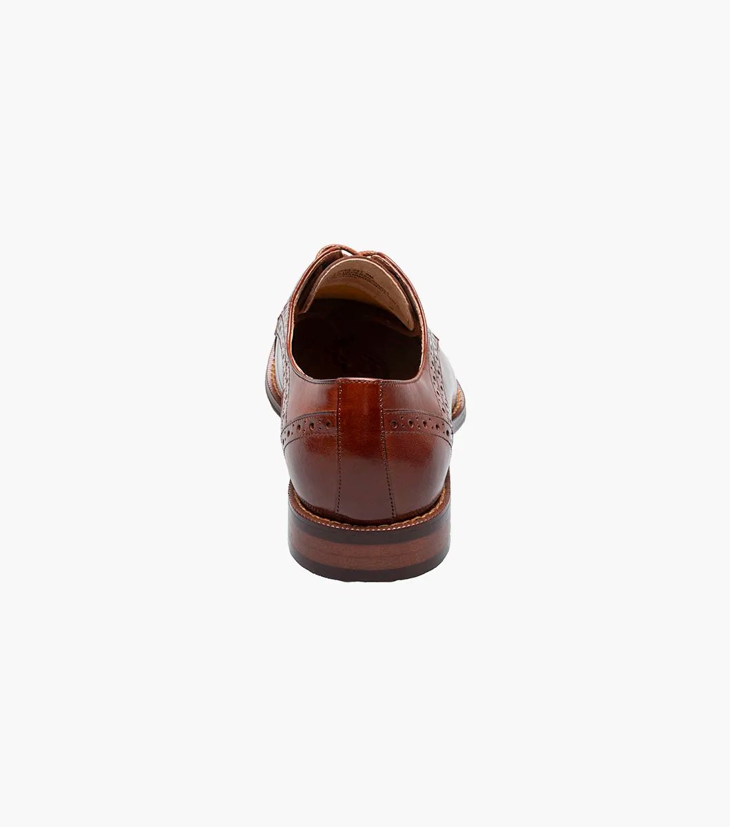 Introducing the Stacy Adams - GARRETT Cap Toe Oxford in Cognac (style number 25543-221) featuring brogue detailing, Buffalo leather upper, and classic laces, set against a white background.