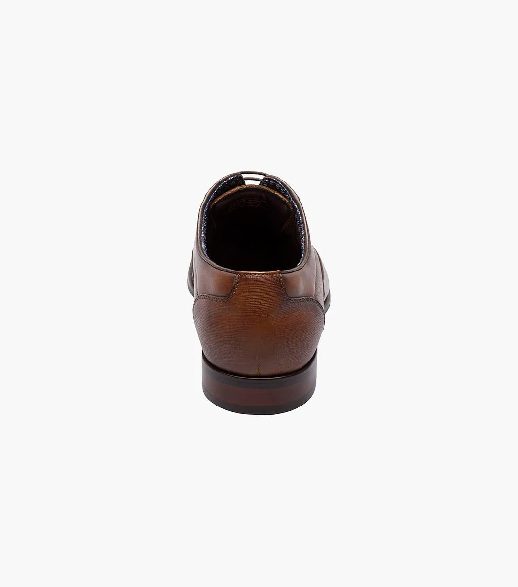 Introducing the Stacy Adams KALLUM Cap Toe Oxford in Cognac, featuring a cap toe and lace-up closure, along with a cushioned footbed for enhanced comfort.