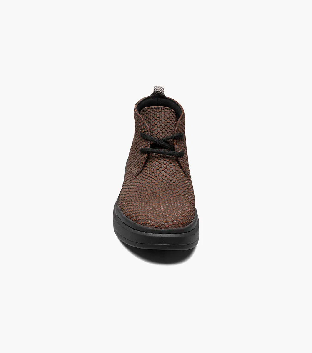 Stacy Adams - CAI Plain Toe Chukka Boot in brown, product code 25566-200, showcases a textured design with a black sole and is photographed on a white background. The boot includes a cushioned insole for enhanced comfort.