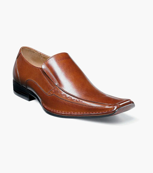 Stacy Adams' TEMPLIN Bike Toe Loafer in cognac showcases a genuine leather design with a stylish pointed toe and subtle stitching detail, set on a black sole. This elegant shoe features a cushioned insole for enhanced comfort, all highlighted against a plain background.