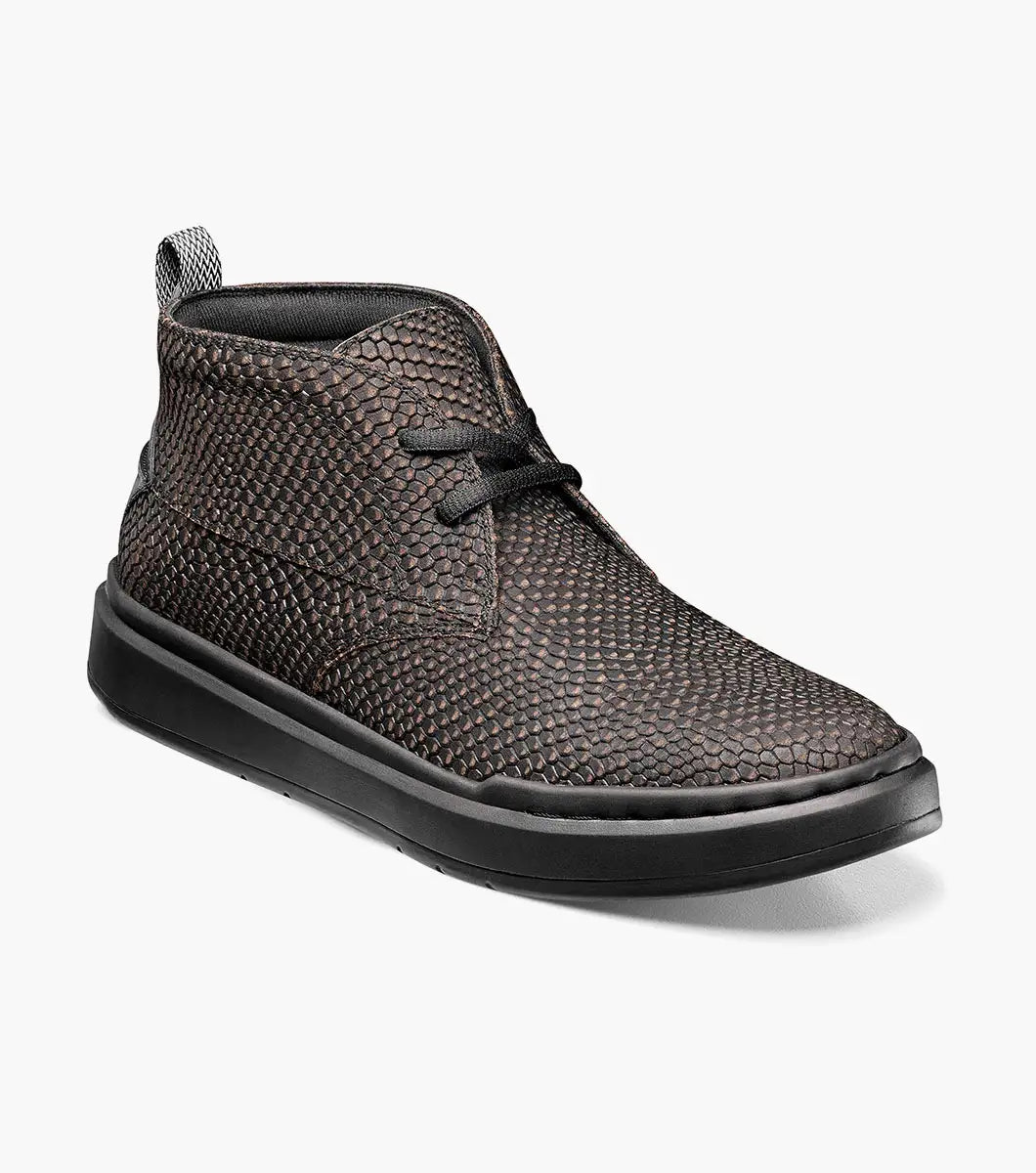 A Stacy Adams CAI Plain Toe Chukka Boot (model 25566-975) in black and gray, showcasing a dark brown textured pattern with black laces and sole, features a cushioned insole and is displayed at an angle on a white background.