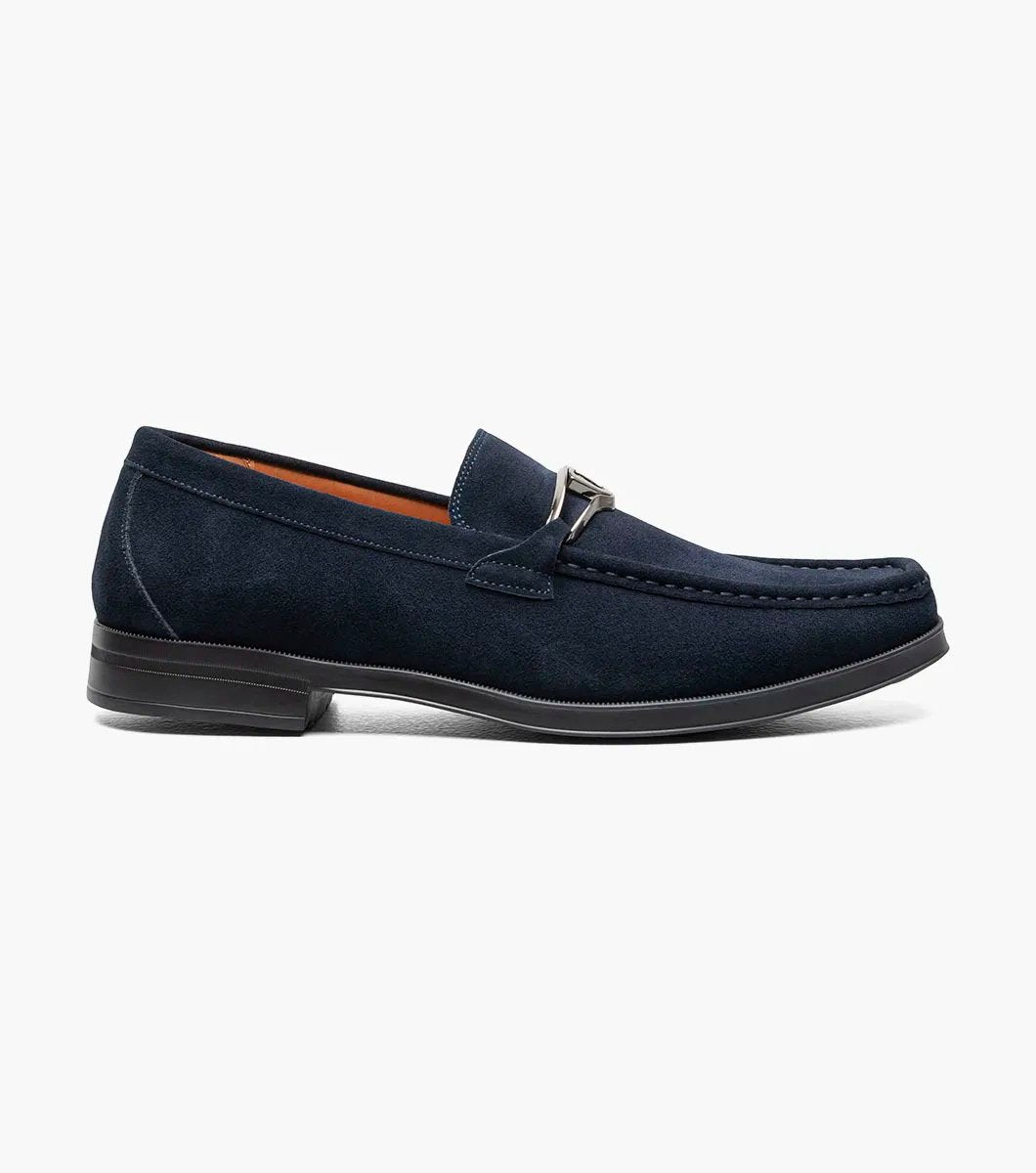 Stacy Adams introduces the PALLADIAN Moc Toe Slip On in Navy Suede (25549-415), showcasing a soft suede upper, metallic buckle detail, and black sole with a fully cushioned insole for exceptional comfort.