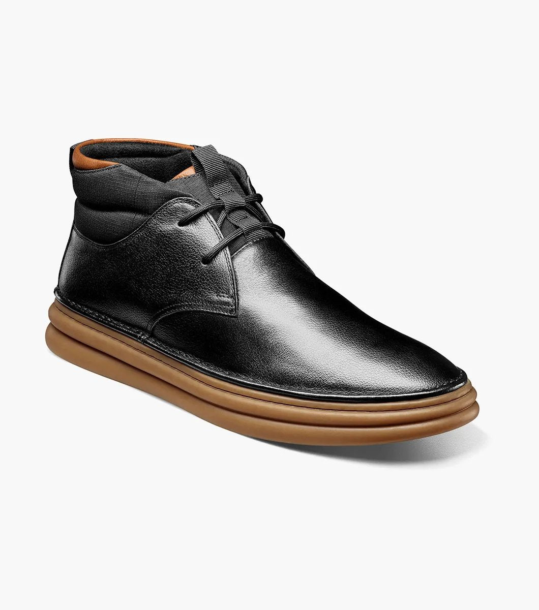 The Stacy Adams DELSON Plain Toe Chukka Boot in black features an ankle-high design with a brown rubber sole, a lace-up closure, and added arch support for comfort.