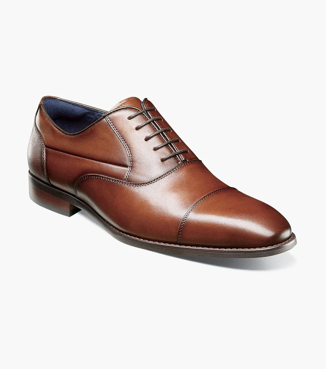 Introducing the Stacy Adams KALLUM Cap Toe Oxford in Cognac, featuring a cap toe and lace-up closure, along with a cushioned footbed for enhanced comfort.