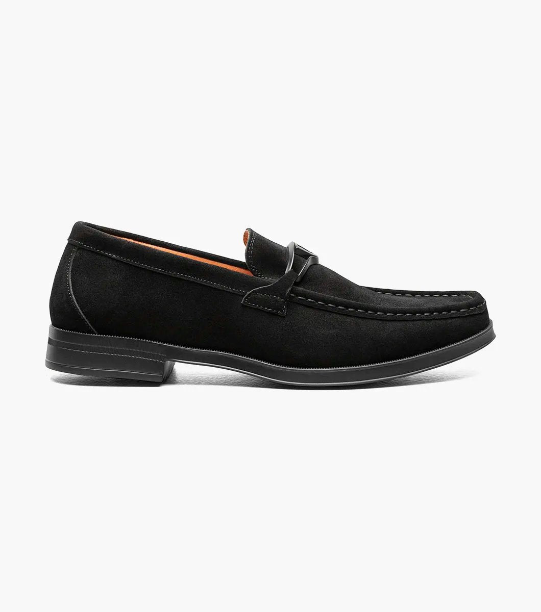 Stacy Adams PALLADIAN Moc Toe Slip On in black suede, featuring a metal buckle detail and stitching accents, complete with a comfortable Memory Foam insole, displayed on a white background.