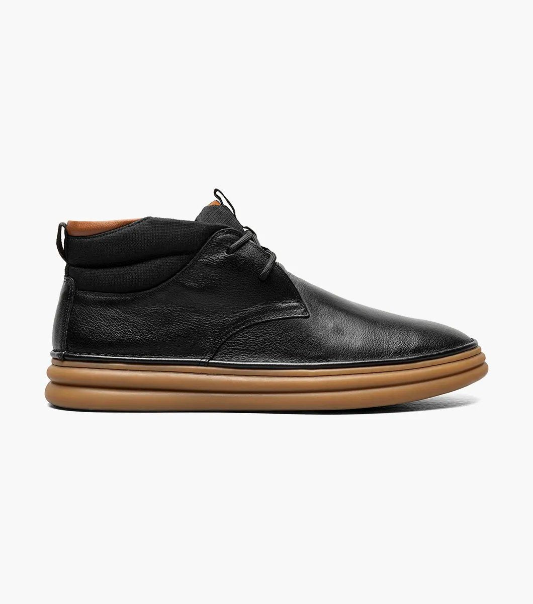 The Stacy Adams DELSON Plain Toe Chukka Boot in black features an ankle-high design with a brown rubber sole, a lace-up closure, and added arch support for comfort.