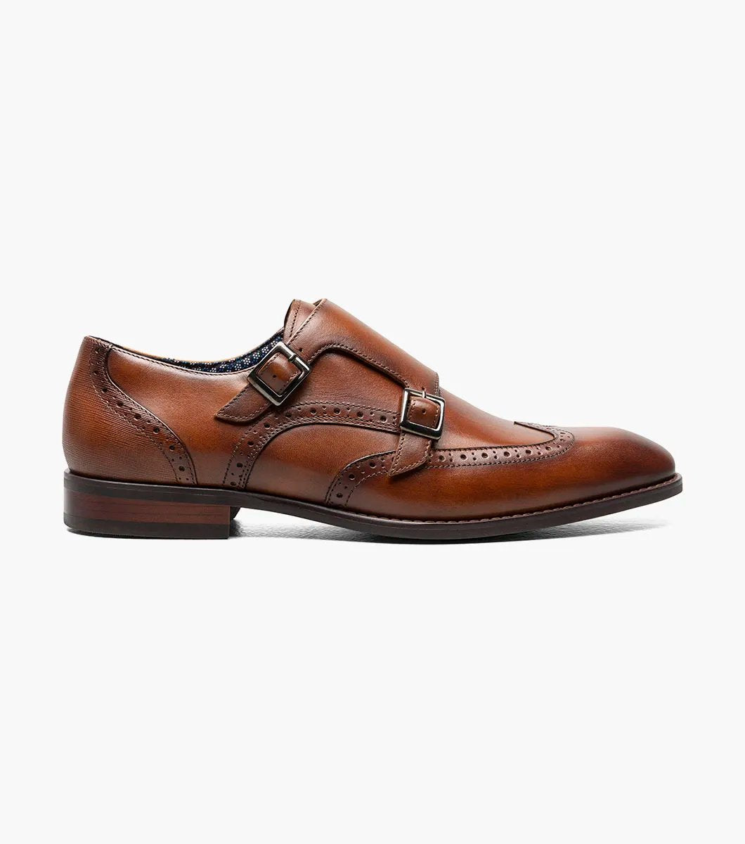 The Stacy Adams - KARSON Wingtip Double Monk Strap in cognac, model number 25570-221, is a shoe crafted with brown leather and features wingtip decorative perforations along with two side buckles, complemented by a RedZone footbed for exceptional comfort.