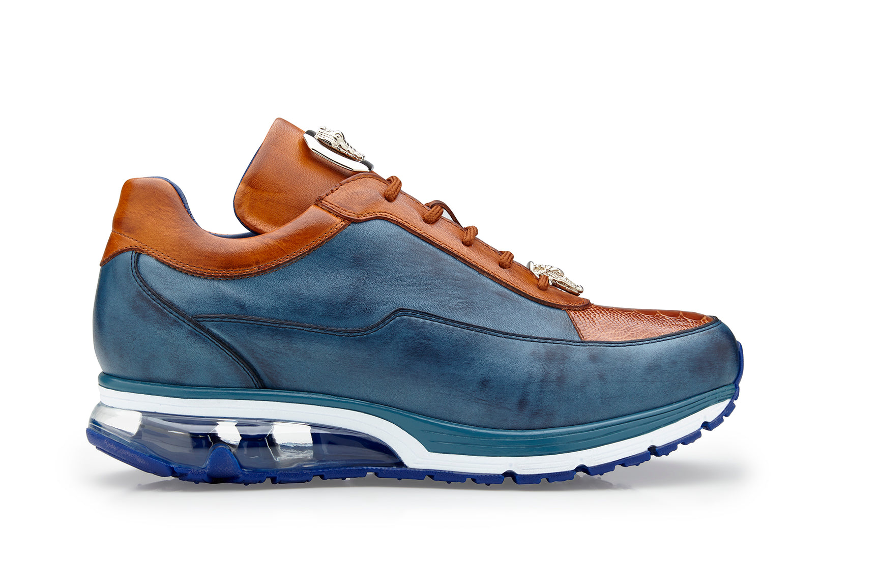 The Belvedere - Flash sneaker by BELVEDERE showcases a luxurious combination of genuine ostrich and soft Italian calf leather in antique blue safari and antique almond hues. This side view highlights a transparent section in the sole paired with a blue tread.